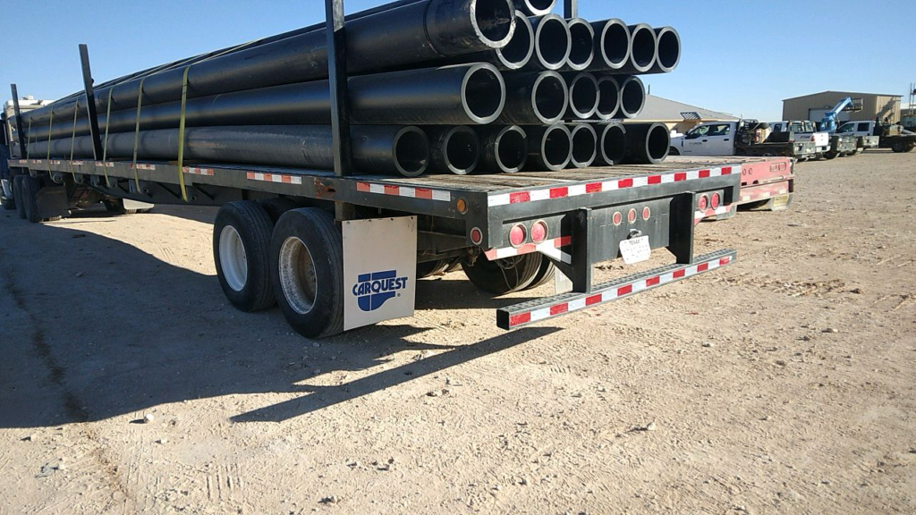 flatbed trailer loaded with delivery of oil and gas pipe
